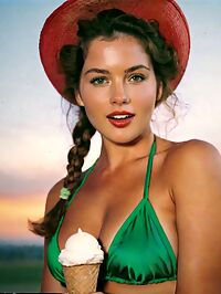 A sultry young woman with French braids and fur scarf stuns in 80s ice cream shop